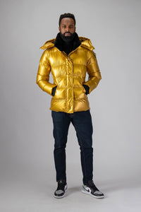 High-end Canadian designer winter coat for men in "Gold" colour. Woodpecker cruelty-free winter coat designed in Canada. Men's heavy weight medium length premium designer jacket for winter. Superior quality warm winter coat for men. Moose Knuckles, Canada Goose, Mackage, Montcler, Will Poho, Willbird, Nic Bayley. Shiny parka. Stylish winter jacket. Designer winter coat.