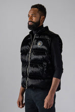 Load image into Gallery viewer, Woodpecker Unisex Winter Vest. High-end Canadian designer winter vest in &quot;All Wet Black&quot; colour. Woodpecker cruelty-free vest designed in Canada. Heavy weight short length premium designer vest for winter. Superior quality warm winter vest. Moose Knuckles, Canada Goose, Mackage, Montcler, Will Poho, Willbird, Nic Bayley. Extra warm. Shiny vest. Stylish winter vest. Designer winter vest.
