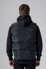 Load image into Gallery viewer, Woodpecker Unisex Winter Vest. High-end Canadian designer winter vest in &quot;Black Diamond&quot; colour. Woodpecker cruelty-free vest designed in Canada. Heavy weight short length premium designer vest for winter. Superior quality warm winter vest. Moose Knuckles, Canada Goose, Mackage, Montcler, Will Poho, Willbird, Nic Bayley. Extra warm. Shiny vest. Stylish winter vest. Designer winter vest.
