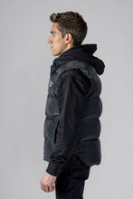 Load image into Gallery viewer, Woodpecker Unisex Winter Vest. High-end Canadian designer winter vest in &quot;Black Diamond&quot; colour. Woodpecker cruelty-free vest designed in Canada. Heavy weight short length premium designer vest for winter. Superior quality warm winter vest. Moose Knuckles, Canada Goose, Mackage, Montcler, Will Poho, Willbird, Nic Bayley. Extra warm. Shiny vest. Stylish winter vest. Designer winter vest.
