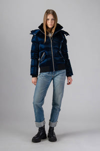 Woodpecker Women's Woody Bomber Winter coat. High-end Canadian designer winter coat for women in shiny “All Wet Navy". Woodpecker cruelty-free winter coat designed in Canada. Women's heavy weight short length premium designer jacket for winter. Superior quality warm winter coat for women. Moose Knuckles, Canada Goose, Mackage, Montcler, Will Poho, Willbird, Nic Bayley. Shiny parka. Stylish winter jacket. Designer winter coat.