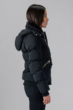 Load image into Gallery viewer, Woodpecker Women&#39;s Woody Bomber Winter coat. High-end Canadian designer winter coat for women in shiny “Matte Black&quot; colour. Woodpecker cruelty-free winter coat designed in Canada. Women&#39;s heavy weight short length premium designer jacket for winter. Superior quality warm winter coat for women. Moose Knuckles, Canada Goose, Mackage, Montcler, Will Poho, Willbird, Nic Bayley. Shiny parka. Stylish winter jacket. Designer winter coat.
