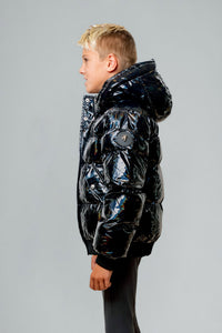 Woodpecker Kids' Chickadee Winter coat. High-end Canadian designer winter coat for Kids in "Oily Black" colour. Woodpecker cruelty-free winter coat designed in Canada. Kids' heavy weight short length premium designer jacket for winter. Superior quality warm winter coat for kids. Moose Knuckles, Canada Goose, Mackage, Montcler, Will Poho, Willbird, Nic Bayley. Extra Warm. Shiny parka. Stylish winter jacket. Designer winter coat.