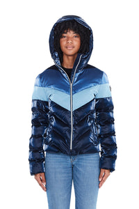 High-end Canadian designer winter coat for women in shiny &quot;blue steel&quot; three-tone blue colour. Woodpecker vegan winter coat designed in Canada. Women's medium weight long length premium designer jacket for winter. Superior quality warm winter coat for women.